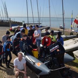 Group image of young sailors and Neil Bevington